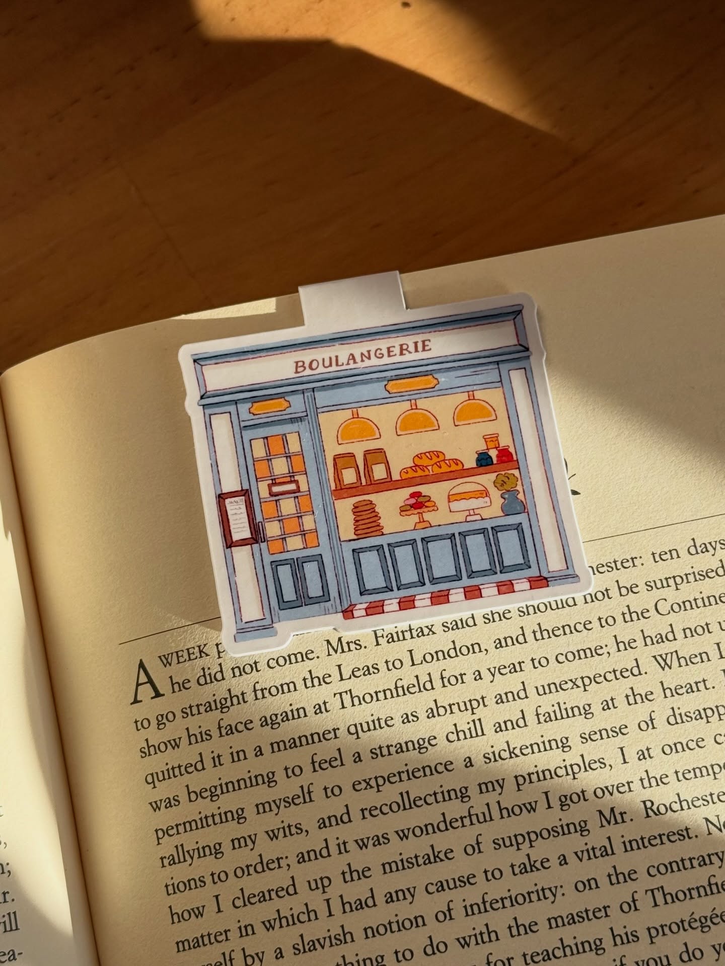 Boulangerie illustrated bookmark resting in an open book