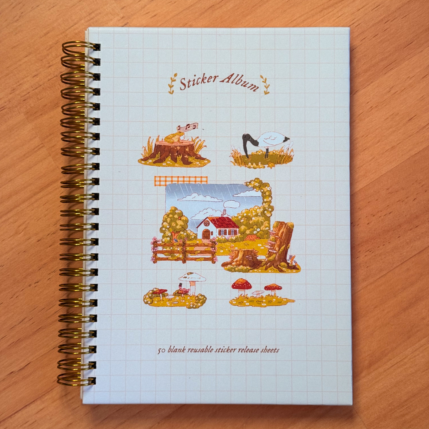 Reusable sticker album with countryside illustrations on the cover